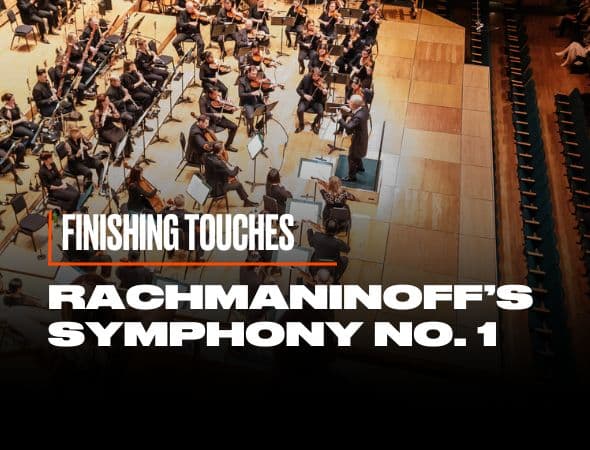 Aerial view of an orchestra rehearsing on a wooden stage. The text overlay reads, Finishing Touches and Rachmaninoffs Symphony No. 1 in bold, white letters. Rows of empty seats are visible on the right.