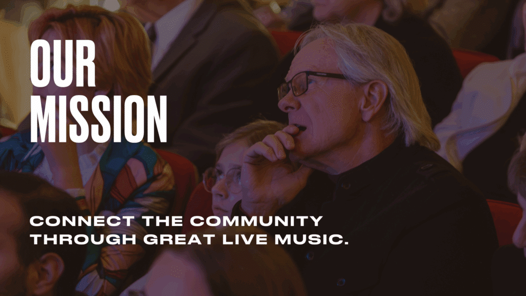 An audience sits in a theater, attentively watching a performance. Text on the image reads: OUR MISSION: Connect the community through great live music.