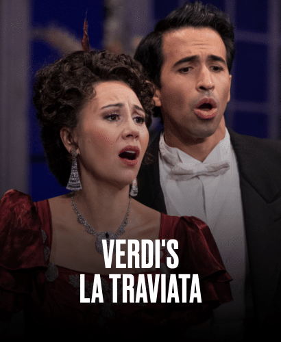 A woman and a man in formal 19th-century attire sing passionately on stage. The woman wears a red dress and jewelry; both appear emotional. Text reads: Verdis La Traviata.