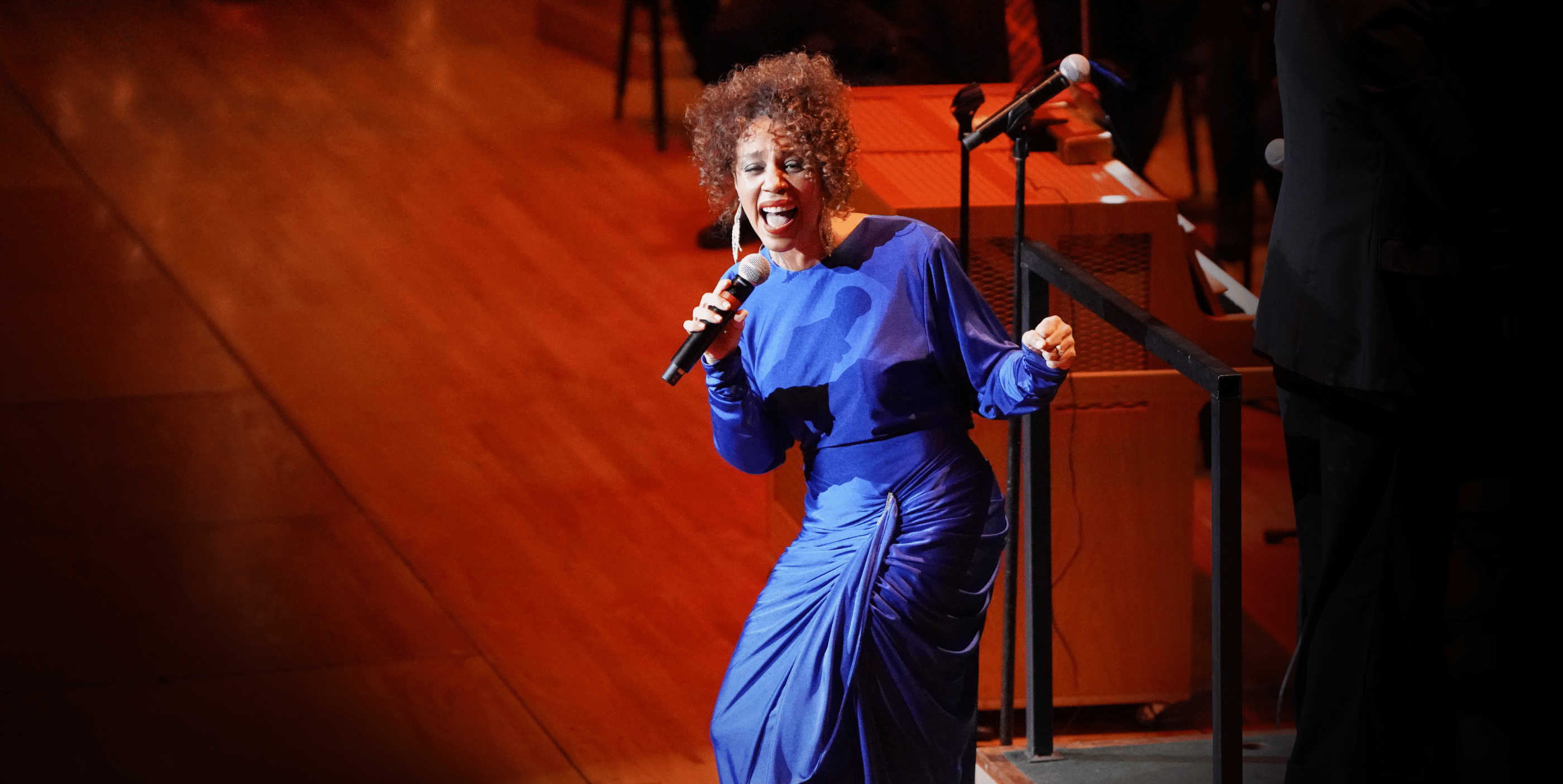 A woman singing into a microphone.