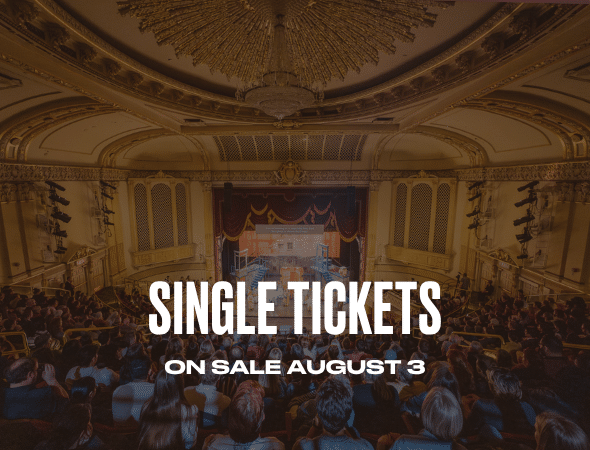 A packed audience in an ornate theater faces a stage, with bold white text overlay reading Single Tickets On Sale August 3.