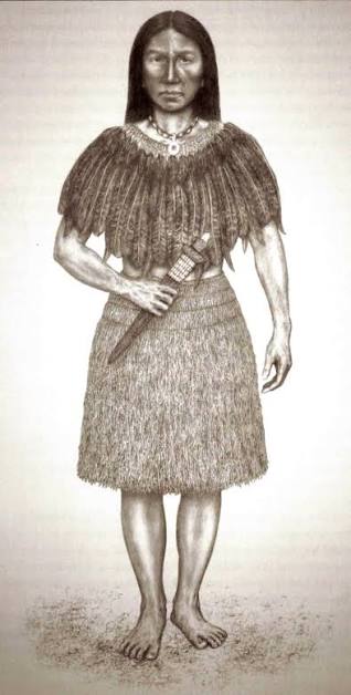 A drawing of Toypurina. A woman stands facing forward wearing traditional Indigenous garments, including a feather-decorated cape and a necklace made of beads or shells. She is holding a sheathed bladed weapon at her waist.