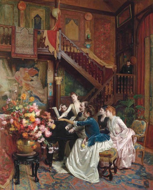 A painting of a 19th-century salon adorned with patterned wallpaper, artwork, and drapery. Four women and a man are gathered around a piano as another man plays. In the background a man leans on the bannister of a staircase. A large bouquet of flowers in a vase is placed on a pedestal table to the left of the piano.”]