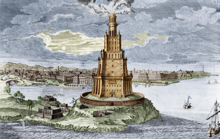 Colored engraving depicting the Lighthouse of Alexandria, also known as Pharos of Alexandria, surrounded by water with sailing ships nearby and a cityscape in the background.